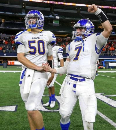 Two football players one with arm up in the air